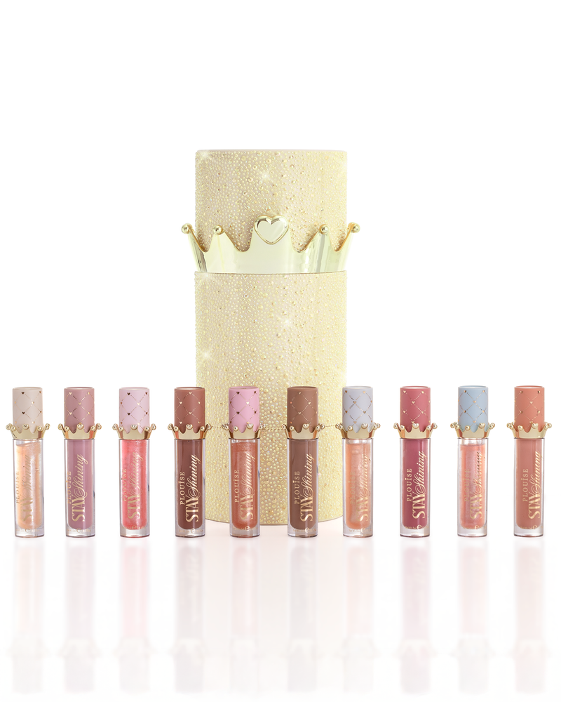 ชุดผลิตภัณฑ์ P.Louise Christmas stay Shining Lip Oil จำนวน 10 ชิ้นจัดเรียงเป็นแถวหน้ากล่องลิปออยล์ทรงกระบอกสีทองแวววาวพร้อมฝาปิดมงกุฎสีทอง บนพื้นหลังสีขาวสะอาด