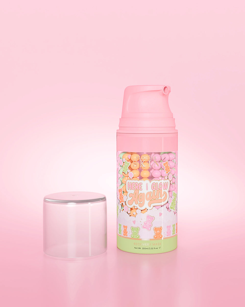 ขวดสีม่วงของ P. Louise Here I Glow Again Candy Bears Recovery Mask บนพื้นหลังสีชมพู