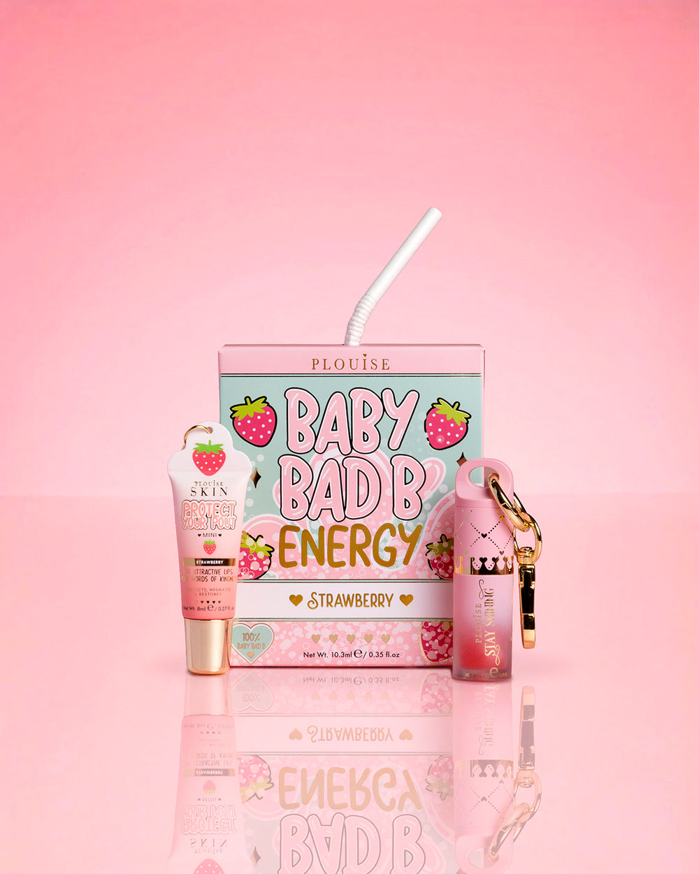 P.Louise Strawberry Baby Bad B Mini Lip Oil & Mini Lip CONditioner บนพื้นหลังสีชมพู